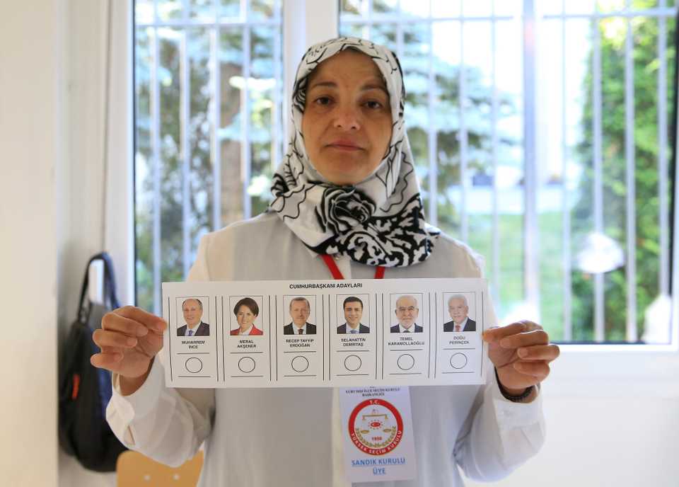 A returning officer shows a ballot paper at a polling station at a consulate general in Berlin on June 7, 2018 in Berlin, Germany.