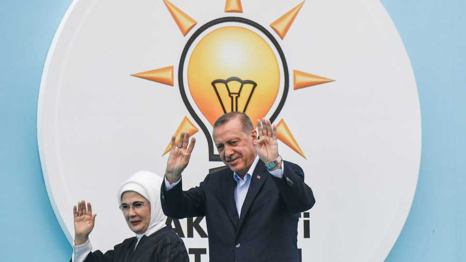 Turkey's President Recep Tayyip Erdogan , leader of the Justice and Development Party (AKP), and his wife Emine, wave as they arrive for an AKP rally in Yenikapi Square in Istanbul on June 17, 2018.