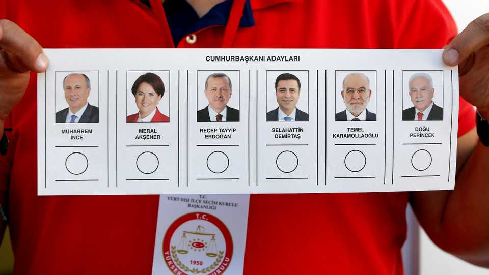 A man presents a ballot card showing the candidates for the presidential election at a polling station at the Turkish consulate general in Berlin, Germany, Thursday, June 7, 2018.