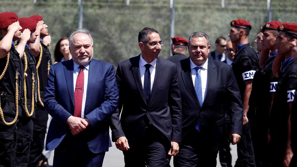 Greek Cypriot Defence Minister Savvas Angelides (C), Israeli Defence Minister Avigdor Lieberman (L) and Greek Defence Minister Panos Kammenos walk before a trilateral meeting in Larnaca, Cyprus on June 22, 2018.