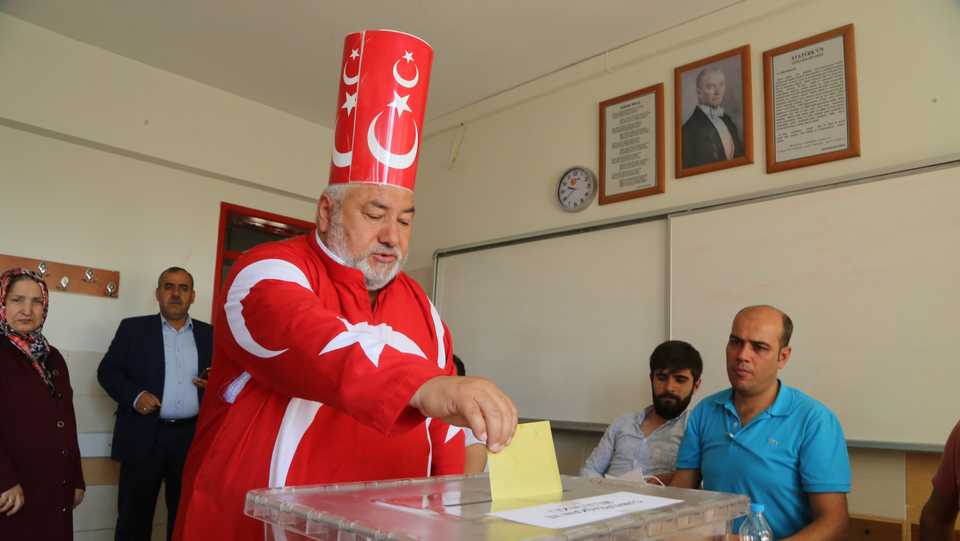 A voter dressed in the Turkish flag cast his ballot at a polling station during the parliamentary and presidential elections in the province of Kahramanmaras, Turkey on June 24, 2018.