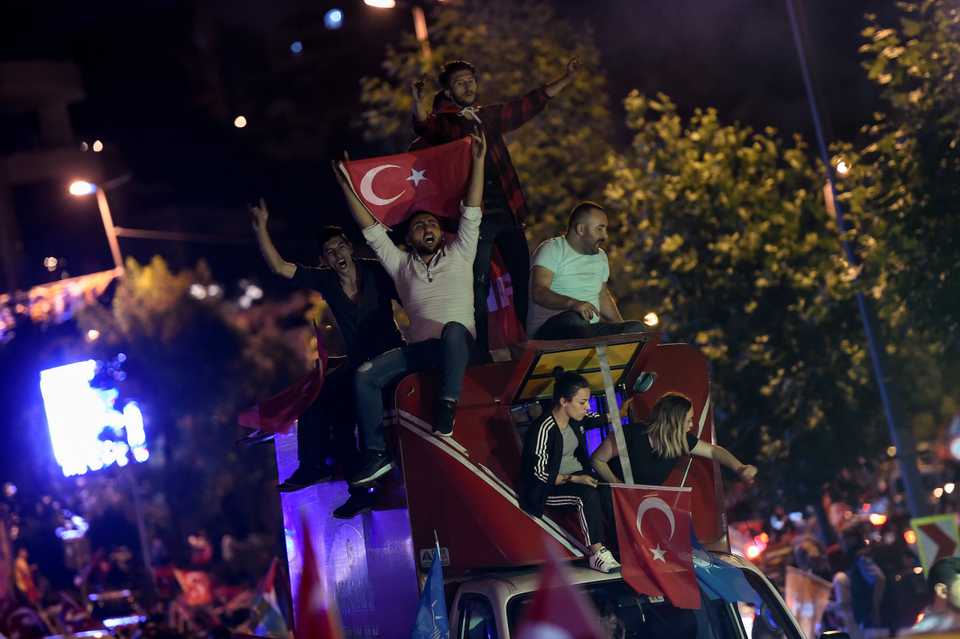Supporters of Turkish President Recep Tayyip Erdogan cheer in front of Turkey's AK Party main office in Istanbul, Turkey, June 24, 2018.