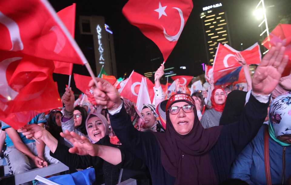 Supporters wave flags in front of the AK Party headquarters in Ankara on June 24, 2018, during the Turkish presidential and parliamentary elections.
