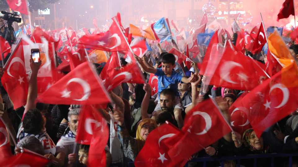 Supporters of Turkish president and the leader of the Justice and Development Party (AK Party) celebrate as unofficial results show Erdogan leading the presidential election in Denizli, Turkey on June 25, 2018.