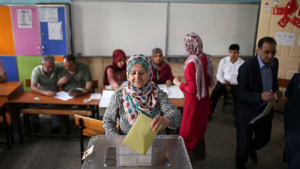 A woman casts her ballot in Turkey's elections at a polling station in the mainly Kurdish city of Diyarbakir, southeastern Turkey, Sunday, June 24, 2018. Turkish voters voted on Sunday in a historic double election for the presidency and parliament.