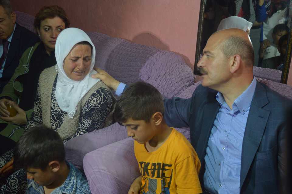 Turkish Interior Minister Suleyman Soylu (R) visits Mevlut Bengi's wife (L) and children in Ciftlik village, Dogubayazit, Agri, Turkey, on July 2, 2018​.