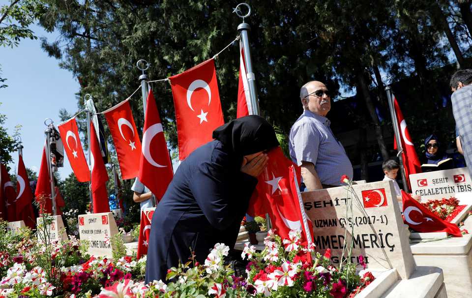 A woman mourns as she visits her son's grave who was killed during an attempted coup in 2016 as she attends a ceremony marking the second anniversary of the failed coup in Ankara, Turkey July 15, 2018.