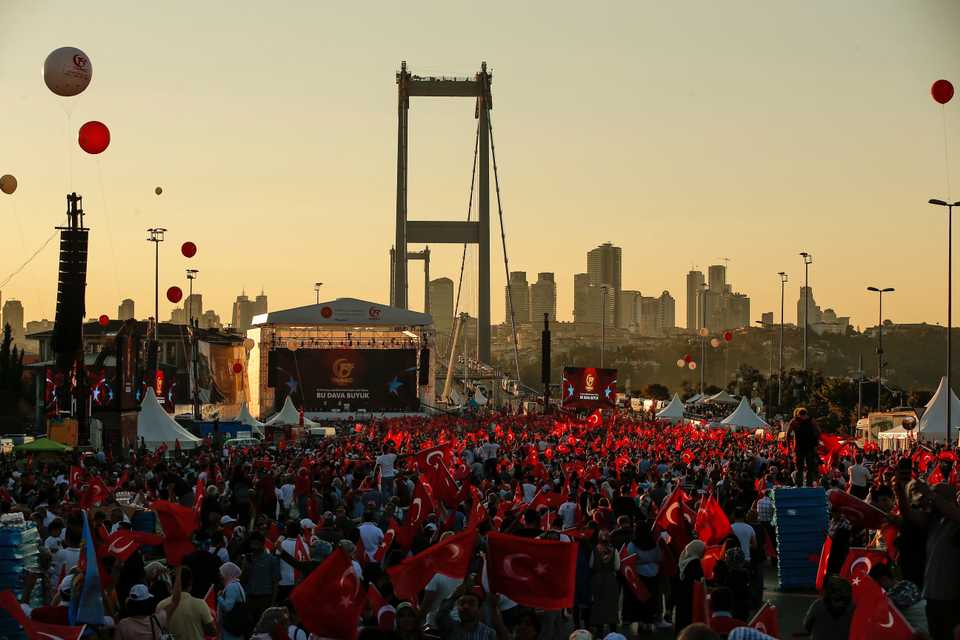 People wave Turkish flags on the road leading to the July 15 Martyr's bridge, during a commemoration ceremony for the second anniversary of a failed coup attempt, in Istanbul, July 15, 2018.