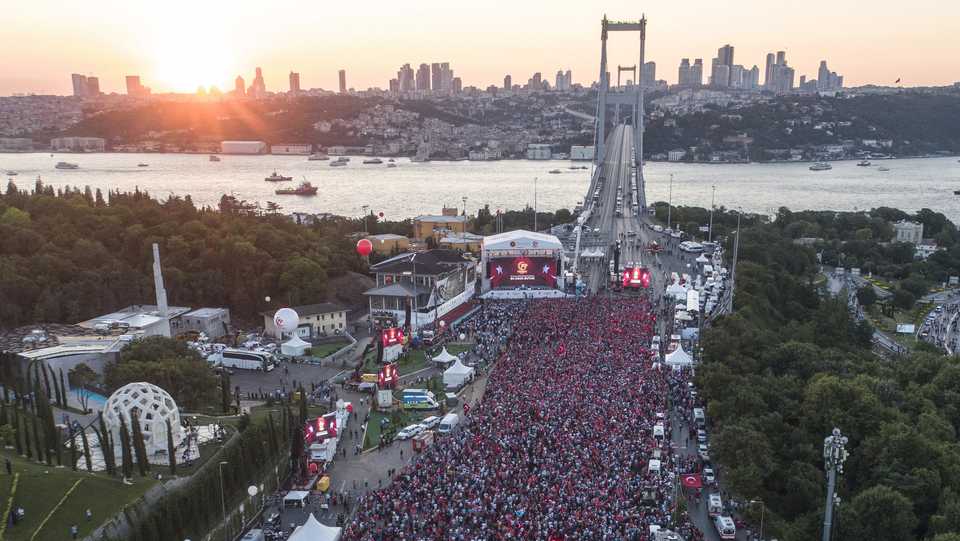 People attend a ceremony marking the second anniversary of the attempted coup at the 15 July Martyrs' Bridge in Istanbul, Turkey, July 15, 2018.