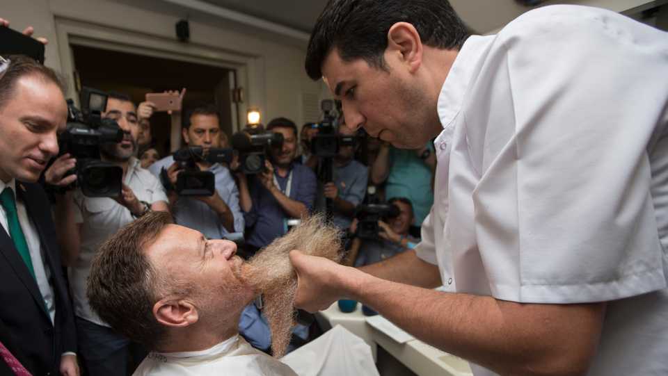Aytug Atici getting his two- year-old beard shaved in the barber, in the National Assembly of Turkey, in Ankara.
