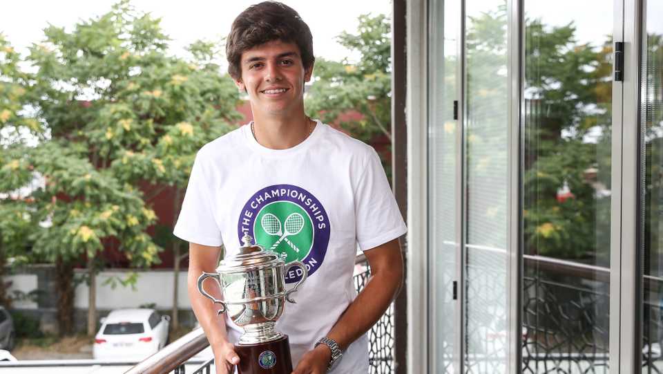 Seventeen-year old Yanki Erel with the trophy that he won at Wimbledon when he and his doubles partner Otto Virtanen claimed the Boys doubles title.