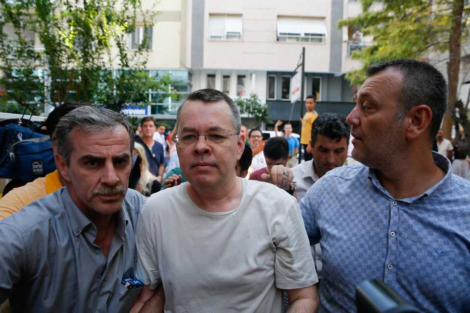 American Pastor Andrew Craig Brunson (C), who was charged with committing crimes, including spying for the PKK terror group and the Fetullah Terrorist Organisation, arrives at the address where he was put under house arrest due to his health problems, in Izmir, Turkey on July 25, 2018.