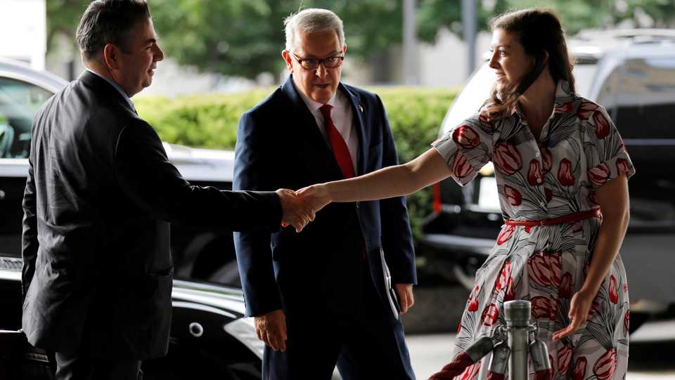 Turkish Deputy Foreign Minister Sedat Onal (L) is greeted by a US State Department protocol official as ambassador to the US Serdar Kilic looks on upon their arrival at the State Department in Washington, US, August 8, 2018.