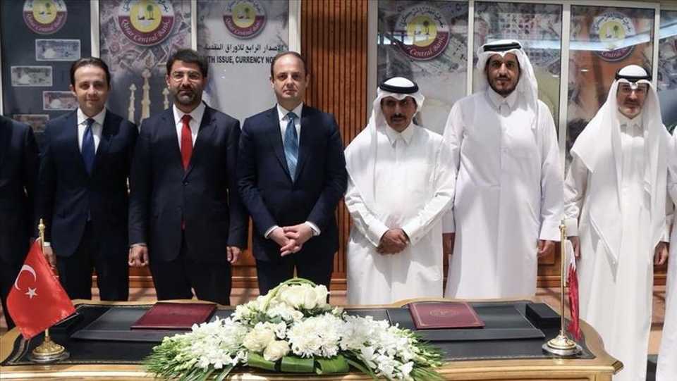 Governor of Central Bank of the Republic of Turkey (CBRT), Murat Cetinkaya (3rd L) and Governor of Qatar Central Bank Sheikh Abdulla Bin Saoud Al-Thani (3rd R) pose for a photo after signing the swap agreement in Doha, Qatar.