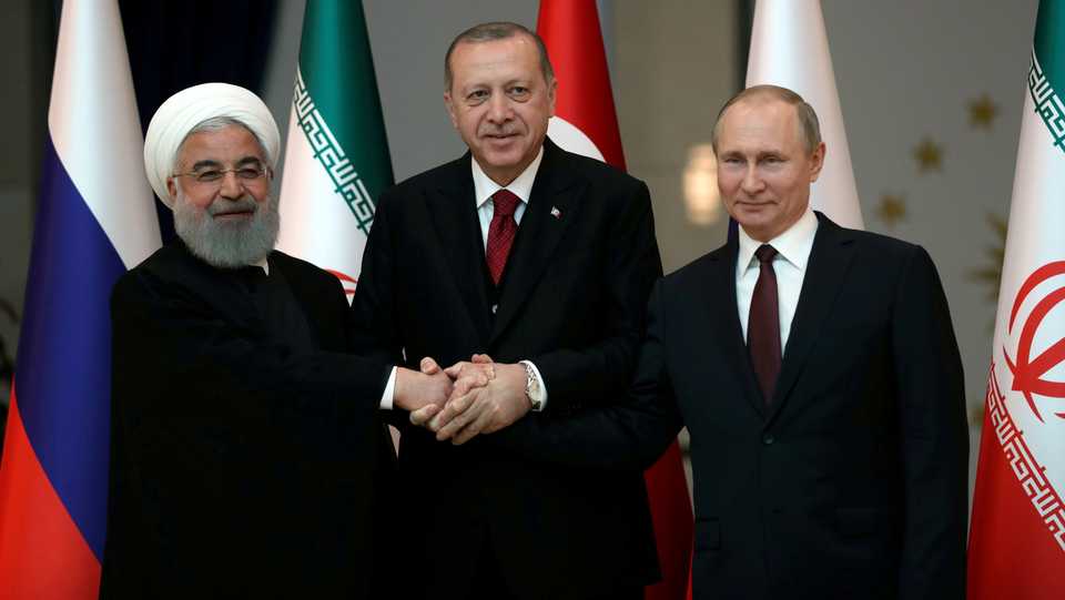 FILE: Presidents Hassan Rouhani of Iran, Tayyip Erdogan of Turkey and Vladimir Putin of Russia pose before their meeting in Ankara, Turkey April 4, 2018