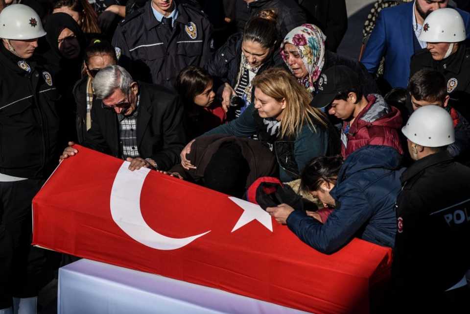 Relatives mourn over the coffin of a Turkish police officer killed in the December 10 attack in Istanbul.