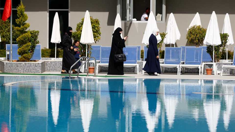 Guests walk by the pool at Elvin Deluxe Hotel, a halal friendly holiday resort, in Alanya, Turkey April 18, 2018.