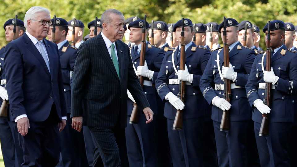 Turkish President Recep Tayyip Erdogan and German President Frank-Walter Steinmeier, left, review the honor guard during a military welcoming ceremony at the presidential palace in Berlin, Germany, Friday, Sept. 28, 2018. Erdogan is on a three-day official state visit to Germany.
