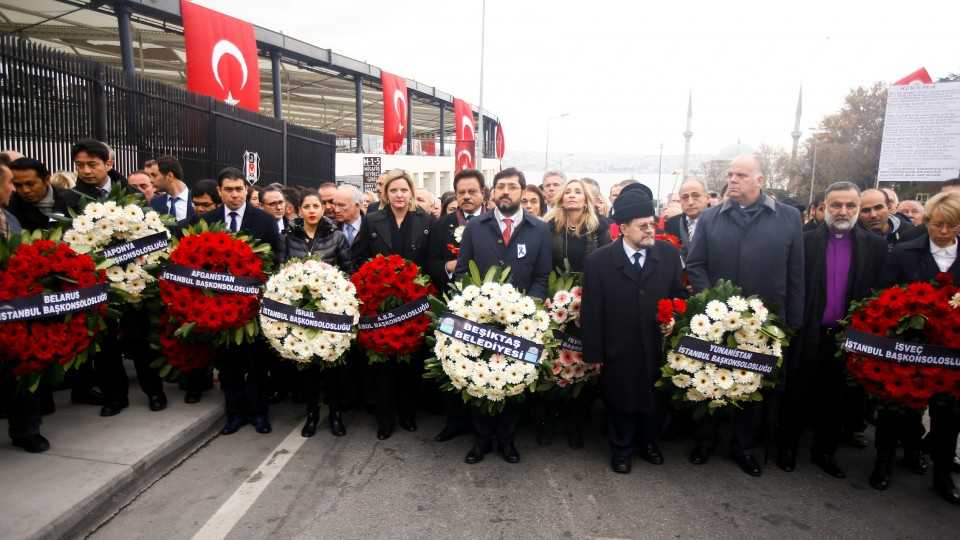 Representatives of foreign missions hold wreaths at the scene of blasts in Istanbul, Turkey, December 12, 2016.