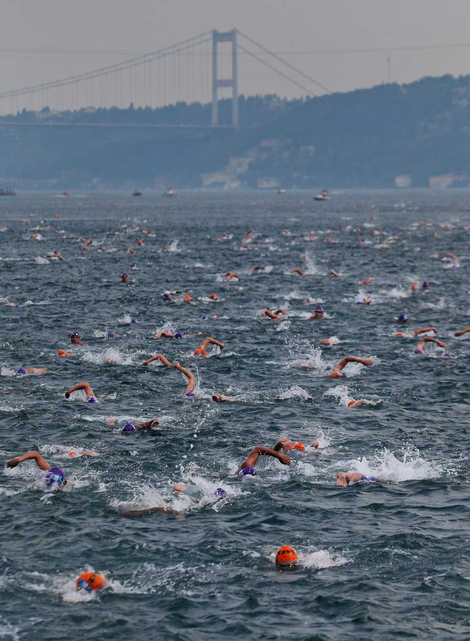 Athletes swim from Asia to Europe in the Bosphorus Strait during the Bosphorus Cross-Continental Swimming Race in Istanbul on July 22, 2018. Over 2,000 open-water competitors plunged into the water from a ferry docked on the city's Asian side and swam for about 6.5 km in the cross-continental event.