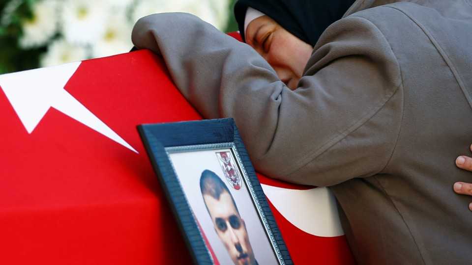 Ayse Barcin, mother of Fehmi Barcin, a Turkish soldier killed in Saturday's blasts in the central Turkish city of Kayseri, mourns during his funeral ceremony in Istanbul, Turkey, December 18, 2016. 