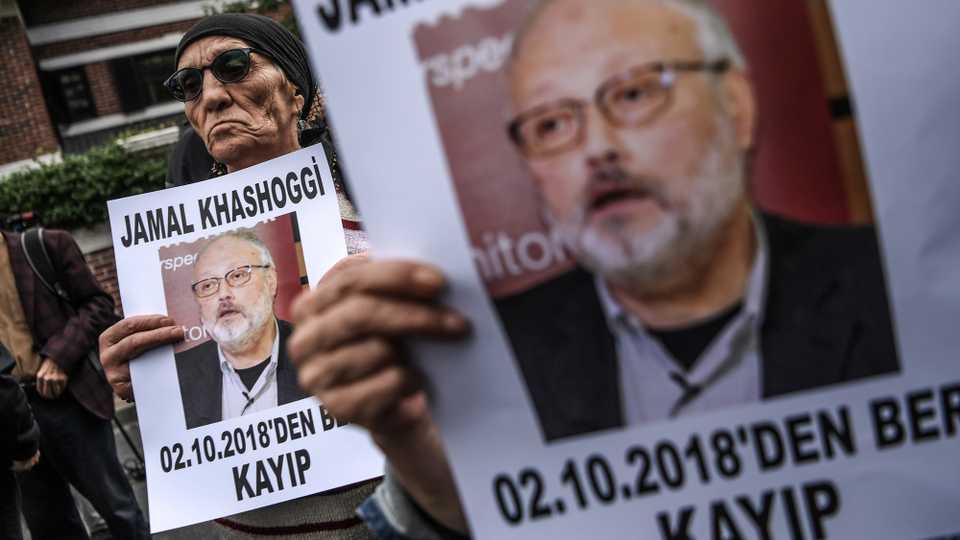 Protesters hold a portrait of missing journalist and Riyadh critic Jamal Khashoggi reading 
