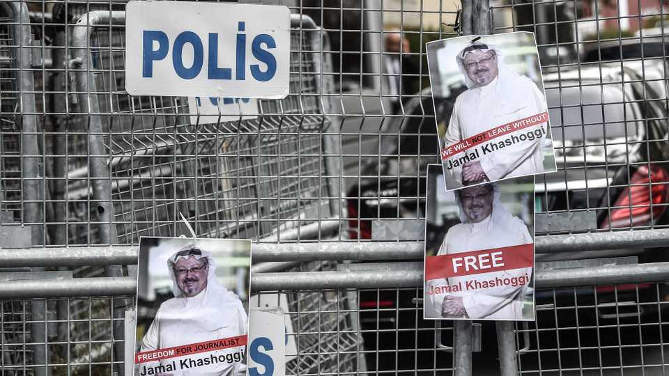 Pictures of missing journalist Jamal Khashoggi are seen on a police fence during a demonstration in front of the Saudi Arabian consulate on October 8, 2018 in Istanbul.