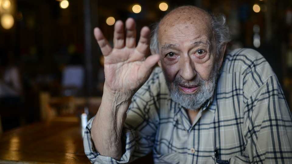 Legendary Turkish photographer Ara Guler poses for a photograph at Ara Cafe on July 7, 2015 in Istanbul.