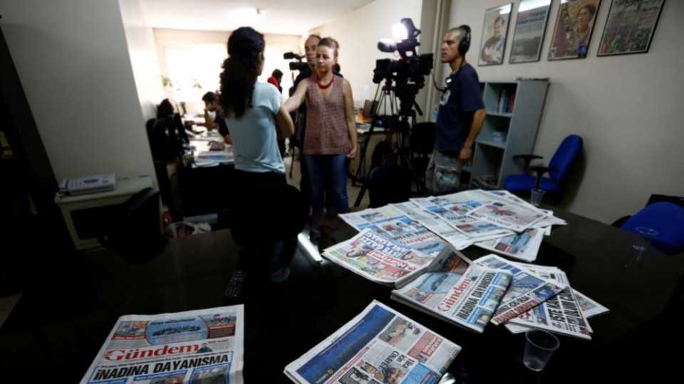 A journalist of Ozgur Gundem gives an interview to a German TV channel at their newsroom before a protest against arrests of the 20 employees of the newspaper, in front of the Ozgur Gundem newspaper in central Istanbul June 21, 2016.
