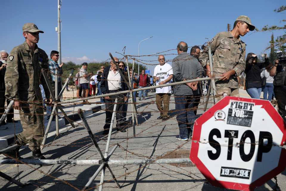 Greek Cypriot forces remove a barbered-wire fence at a newly opened checkpoint in Dherynia, Cyprus on November 12, 2018.