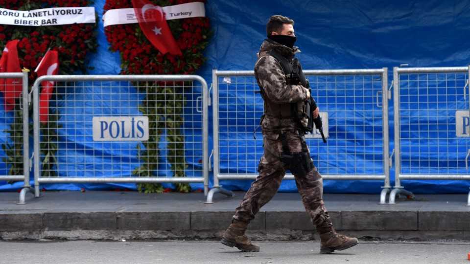 A Turkish special force police officer patrols in front of the Reina nightclub in Istanbul.