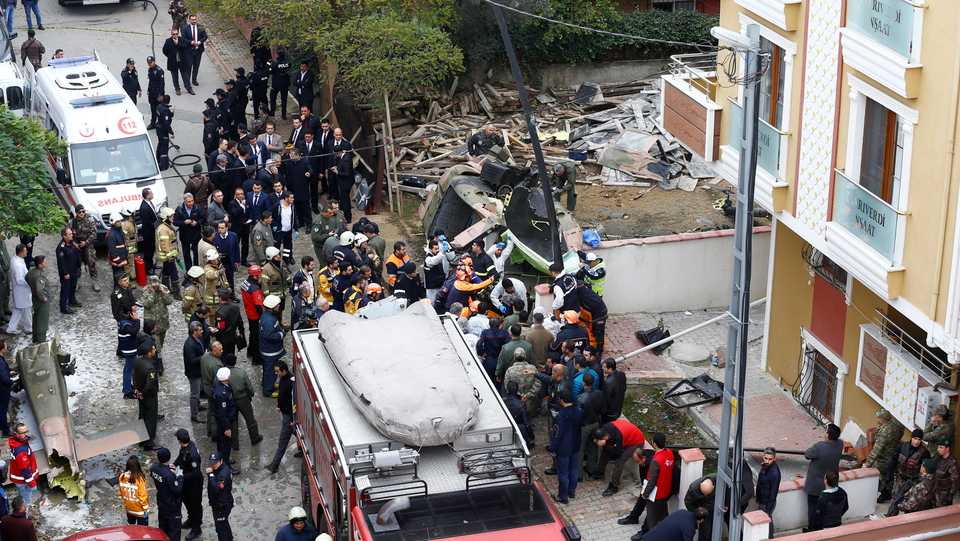 Rescue workers and investigators work at the site of a helicopter crash in Istanbul, Turkey, November 26, 2018,