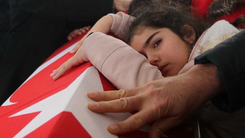 Nisa, the 8-year-old daughter of police officer Fethi Sekin, who was killed in the Izmir courthouse attack on Thursday, mourns her father during his funeral in Izmir, Turkey, January 6, 2017.