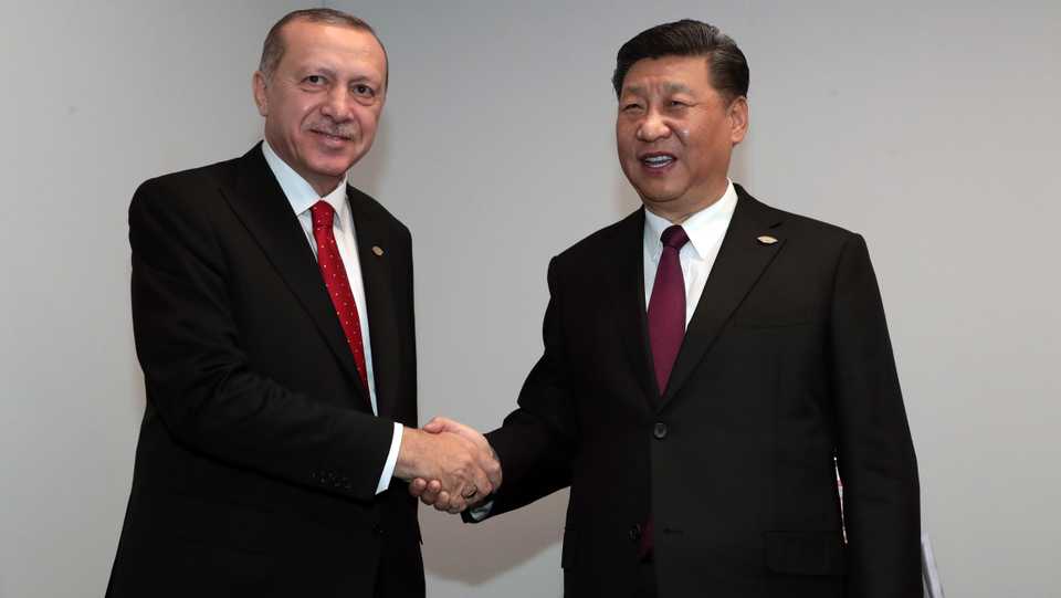 Turkey's President Recep Tayyip Erdogan (L) and Chinese President Xi Jinping (R) shake hands during their meeting within the G20 Leaders’ Summit in Buenos Aires, Argentina on November 30, 2018.