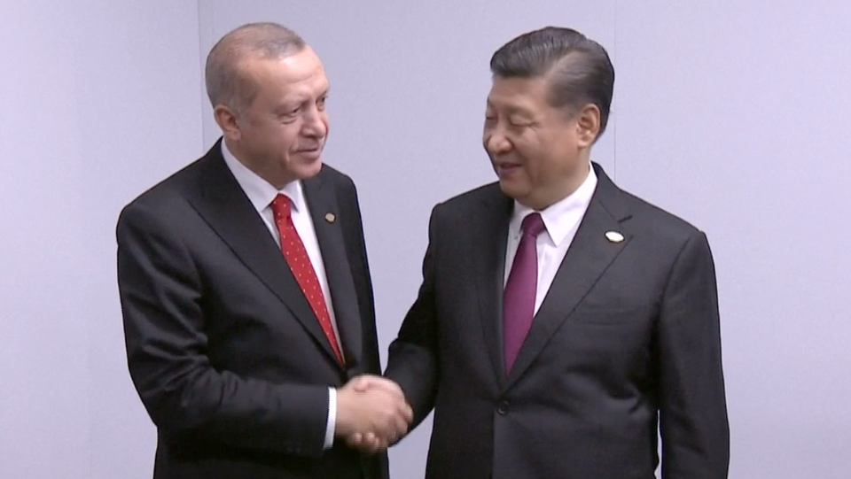 Turkish President Recep Tayyip Erdogan and Chinese President Xi Jinping shake hands during the sidelines of the G20 summit being held in Argentina on November 30, 2018.