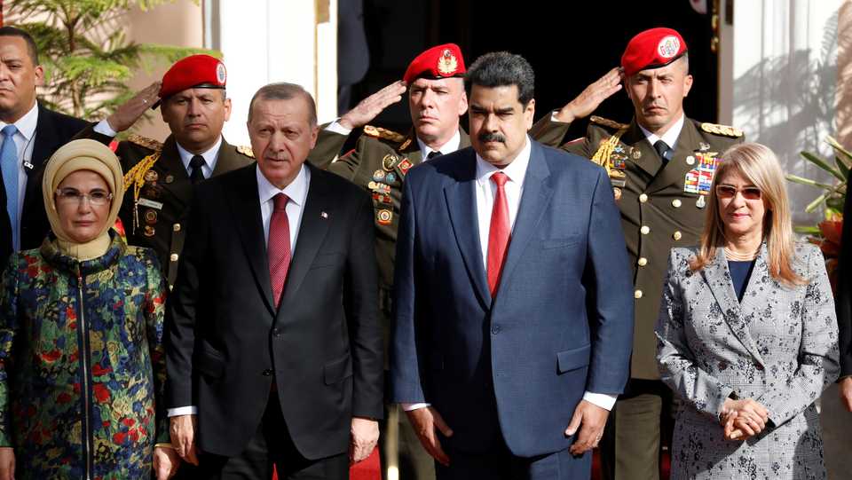 Turkish President Recep Tayyip Erdogan receives military honours upon his arrival at Miraflores Palace, next to Venezuela's President Nicolas Maduro, his wife Emine Erdogan, and President Maduro's wife Cilia Flores, in Caracas, Venezuela on December 3, 2018.