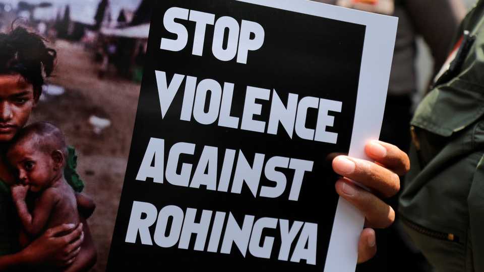 A protester holds a placard during protest against Myanmar's treatment of its Rohingya Muslim minority in front of Myanmar's embassy in Jakarta, Indonesia, December 5, 2018.