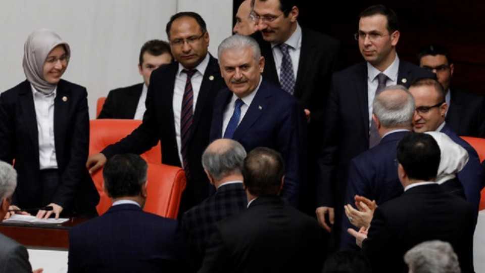 Turkish Prime Minister Binali Yildirim (C) arrives for a debate on the proposed constitutional changes as he is surrounded by MPs at the Turkish Parliament in Ankara, Turkey, January 12, 2017.