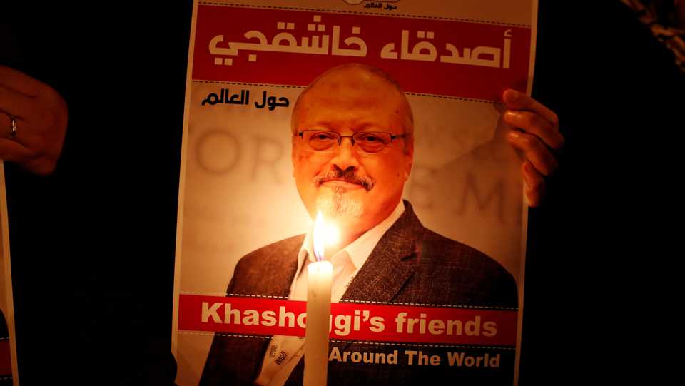 A demonstrator holds a poster with a picture of Saudi journalist Jamal Khashoggi outside the Saudi Arabia consulate in Istanbul, Turkey October 25, 2018.