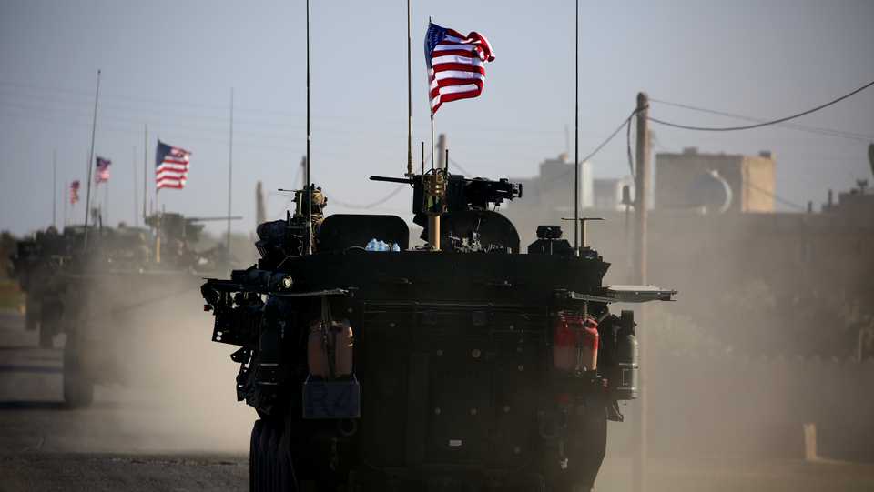 In this file photo taken on March 05, 2017 A convoy of US forces armoured vehicles drives near the village of Yalanli, on the western outskirts of the northern Syrian city of Manbij.