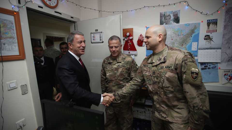 Turkish National Defense Minister Hulusi Akar (L) greets a U.S soldier during his visit to the Turkish Task Force Command in Kabul, Afghanistan on December 22, 2018.