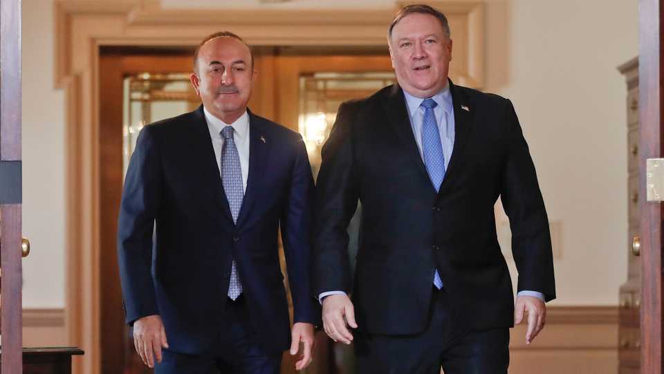 Secretary of State Mike Pompeo, right, and Turkish Foreign Minister Mevlut Cavusoglu, left, walk out together to meet members of the media at the State Department in Washington, November 20, 2018.