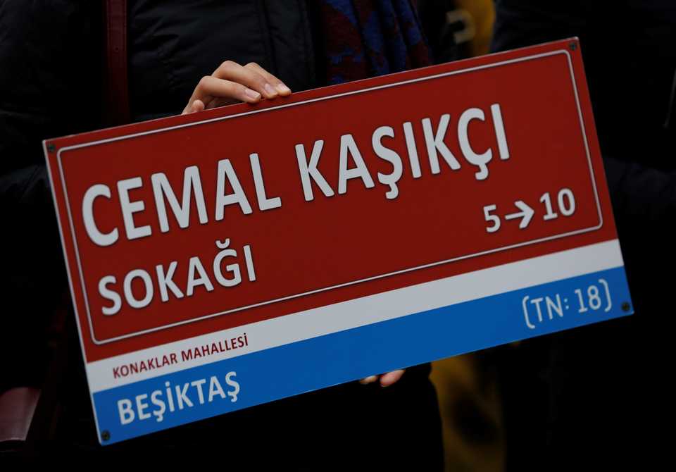 A member of Amnesty International Turkey holds a symbolic street sign during a demonstration to mark 100 days since Saudi journalist Jamal Khashoggi was killed at the Saudi consulate in Istanbul, Turkey.