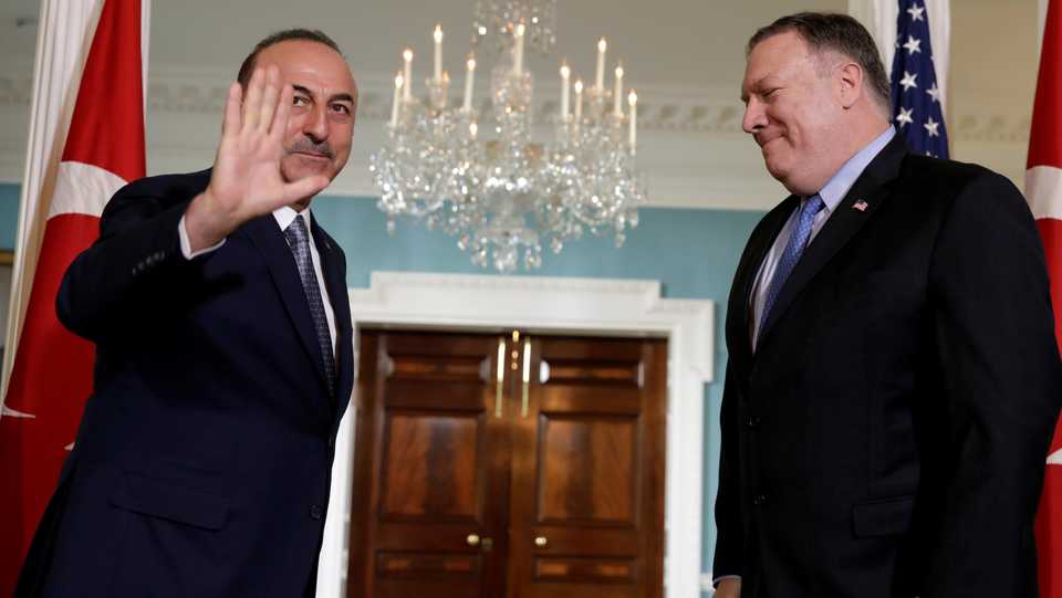 Turkey's Foreign Minister Mevlut Cavusoglu (L) waves to the media before a meeting with US Secretary of State Mike Pompeo (R) at the State Department in Washington, US, November 20, 2018.