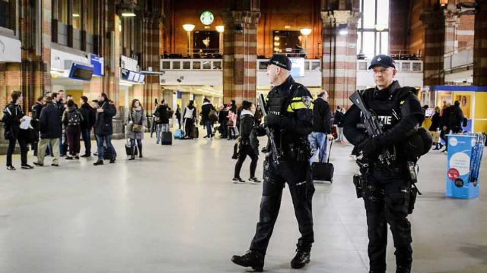 Dutch officers carry out extra patrols at the Central Station in Amsterdam, The Netherlands, March 22, 2016, following the triple bomb attacks in the Belgian capital that killed about 35 people.