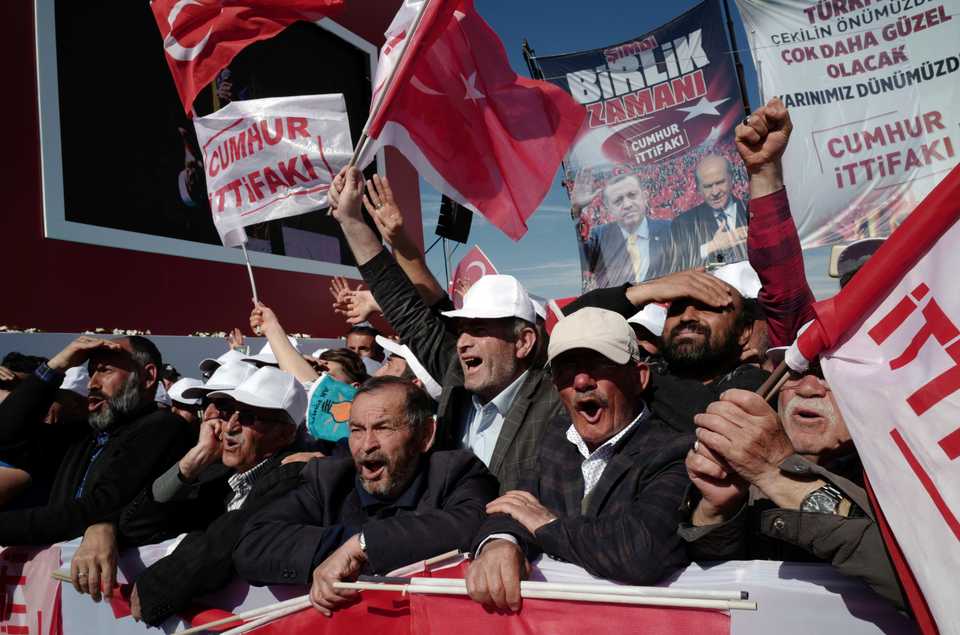 People react as Turkey's President Recep Tayyip Erdogan addresses the supporters of opposition Nationalist Movement Party, MHP, and governing AK Party during a joint rally in Ankara, Turkey, Saturday, March 23, 2019.
