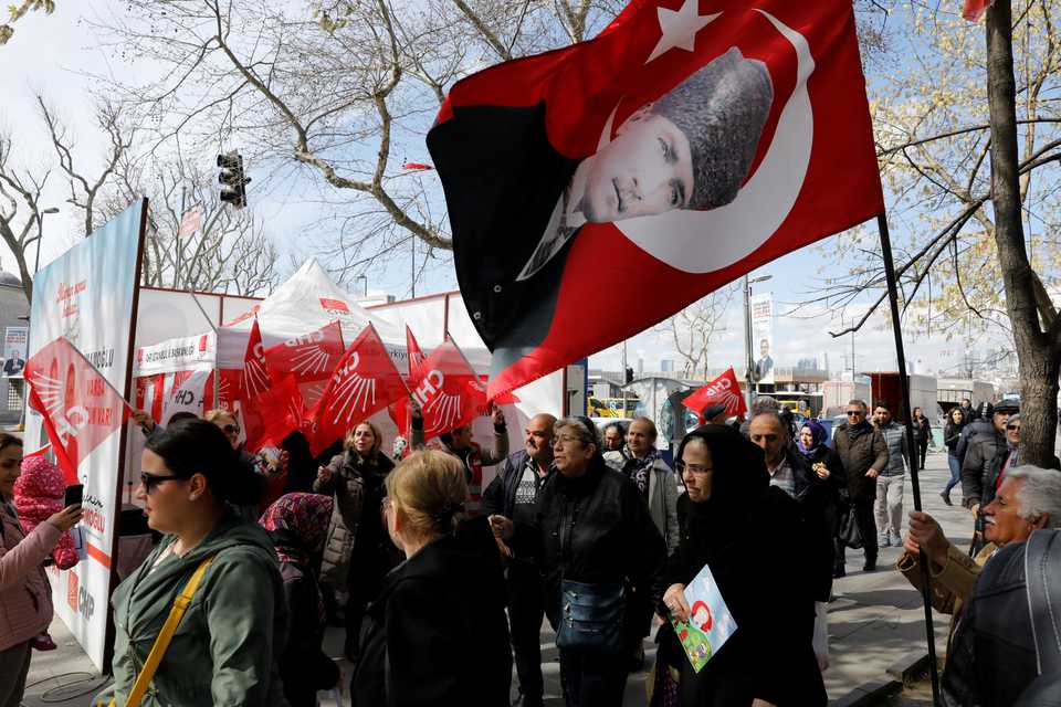 Supporters of main opposition Republican People's Party (CHP) wave party flags as one holds a portrait of Mustafa Kemal Ataturk, founder of modern Turkey, during a campaign event for the upcoming local elections in Istanbul, Turkey. (March 28, 2019)