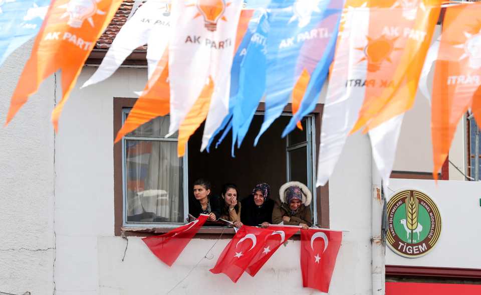 Supporters wave Turkish flags from their apartment during a AKP (Justice and Development Party) campaign rally ahead of the local elections in Ankara, Turkey. (March 28, 2019)