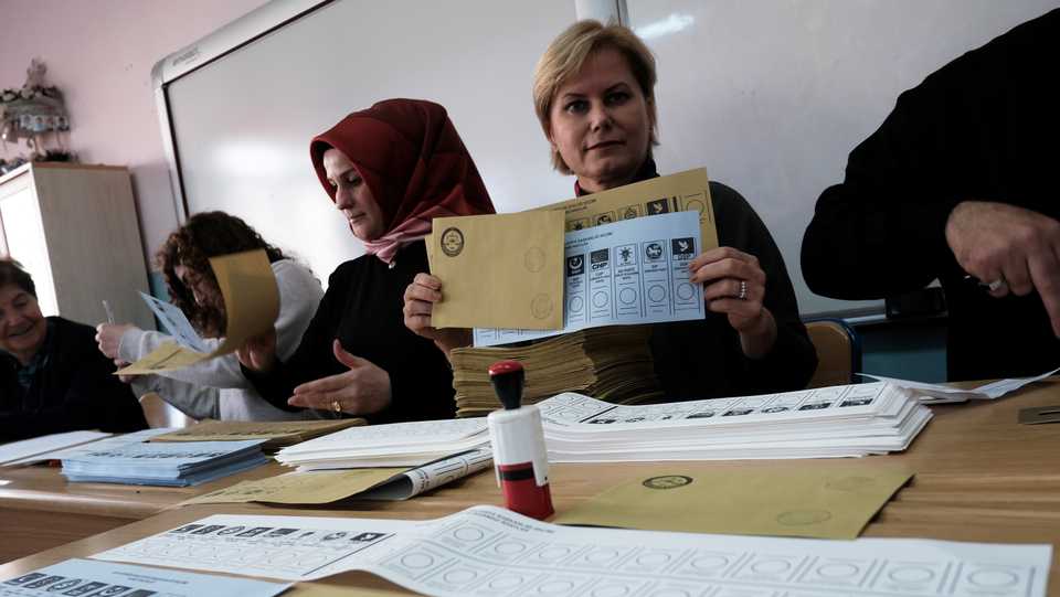 An election official holds voting ballots at a polling station during local elections in Istanbul on March 31, 2019.