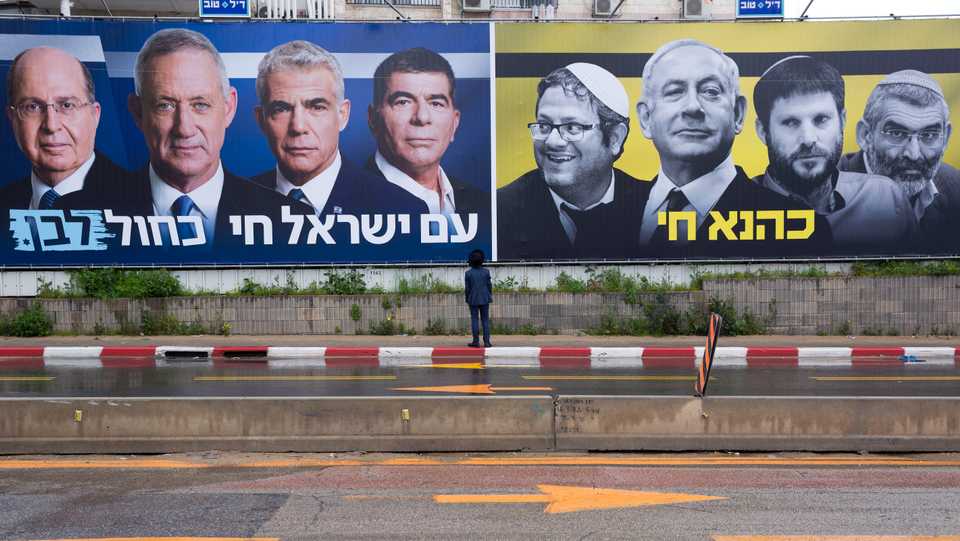 An Ultra-Orthodox Jewish man looks at an elections billboards of the Blue and White party leaders, from left to right, Moshe Yaalon, Benny Gantz, Yair Lapid and Gabi Ashkenazi, alongside a panel on the right showing Prime Minister Benjamin Netanyahu flanked by extreme right politicians, from the left, Itamar Ben Gvir, Bezalel Smotrich and Michael Ben Ari in Bnei Brak, Israel, Saturday, March 16, 2019.
